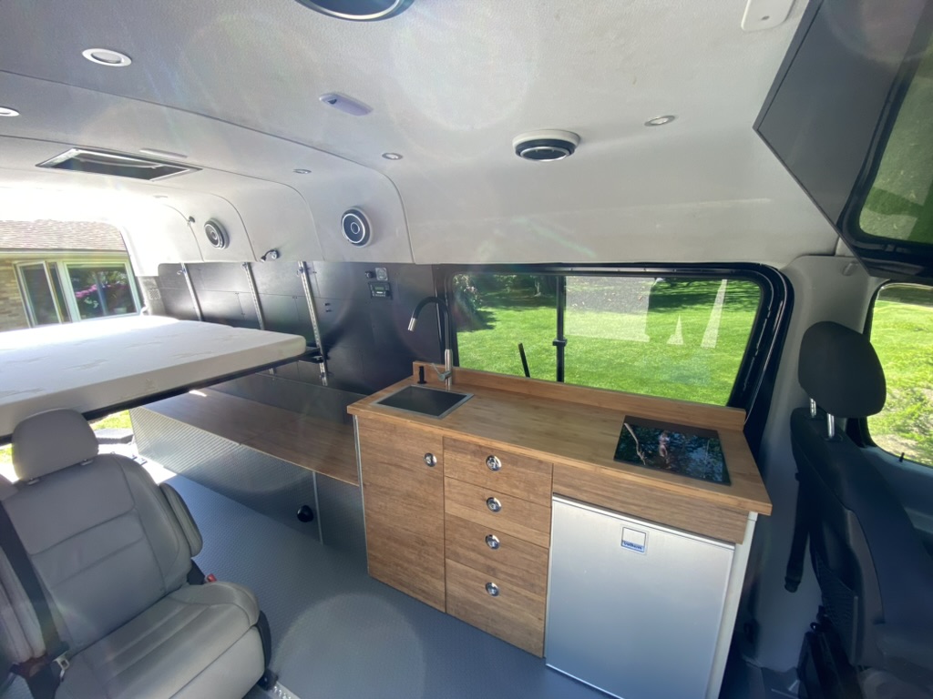 Completed Keystone van interior with wood galley and seating