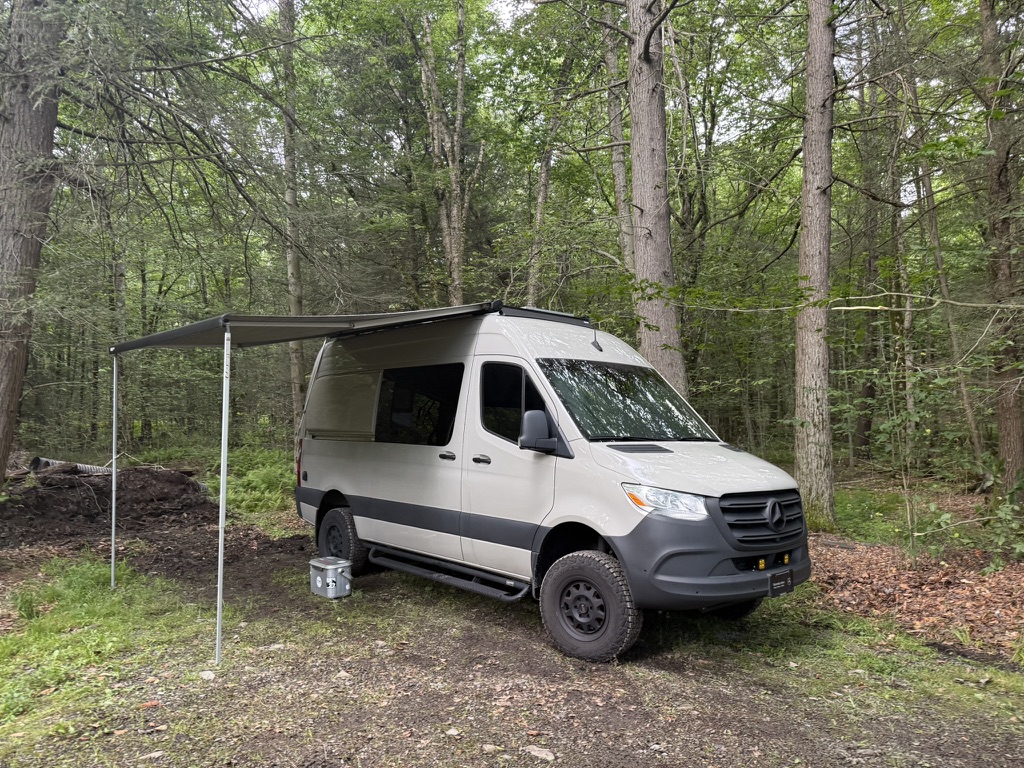 Finished Keystone Sprinter at a forest campsite