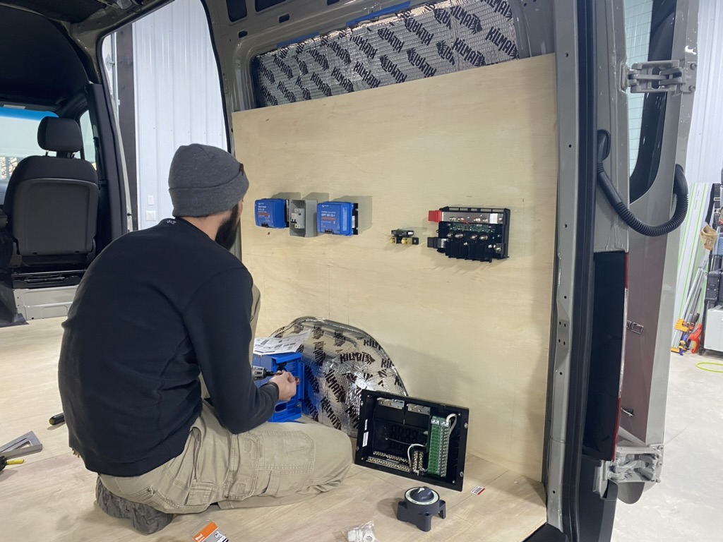 Builder installing the electrical layout inside a Keystone van